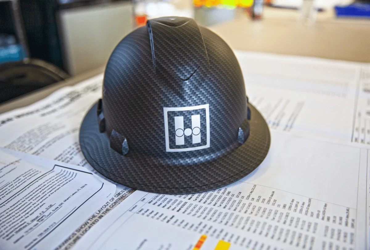 Project managers coordinating procurement with trade partners at Hernandez Development & Construction